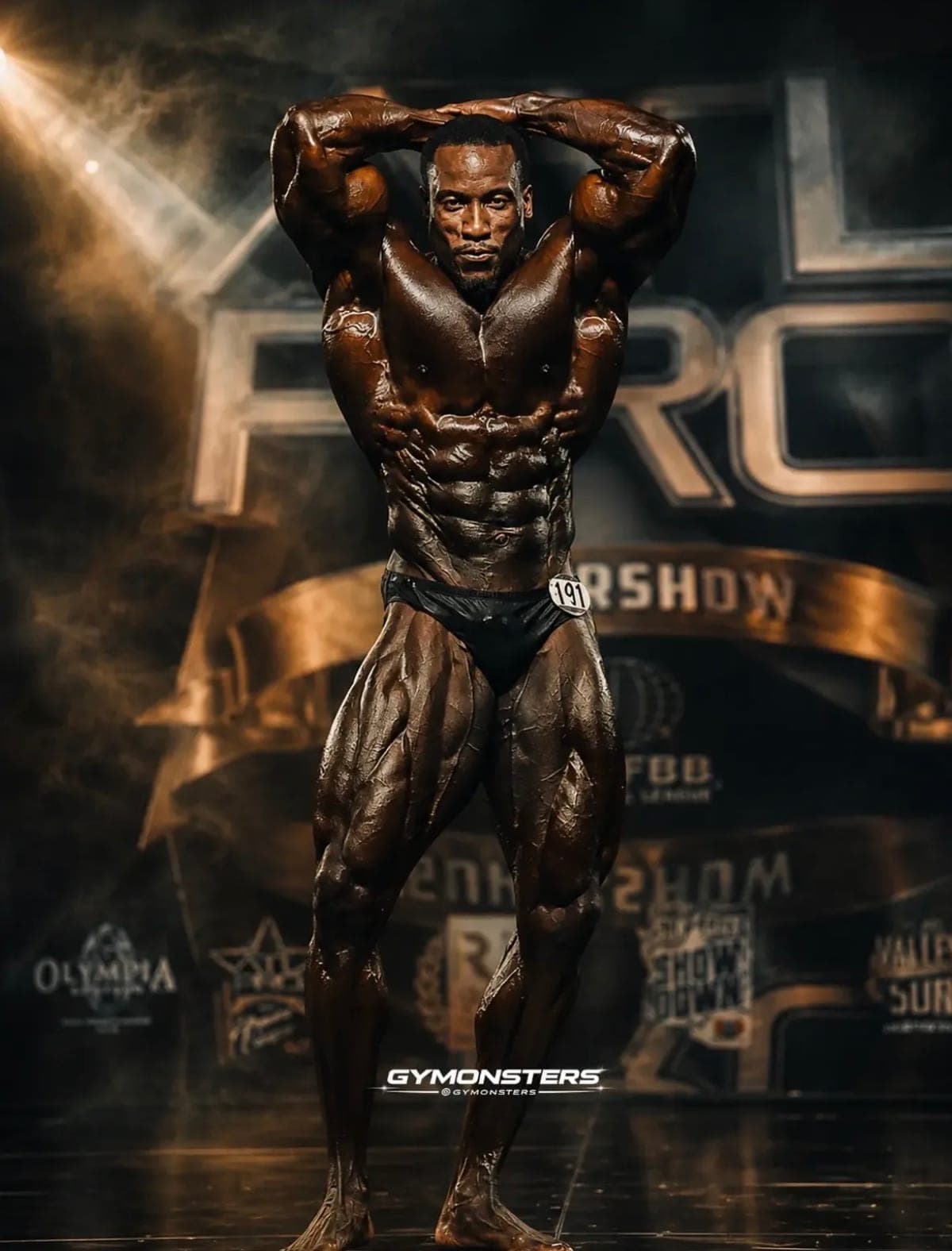 Robert Timms holding an overhead pose on stage at the ATL Pro Supershow